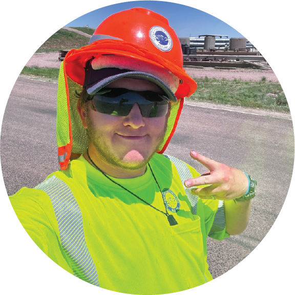 Student building a truss as teacher looks on.